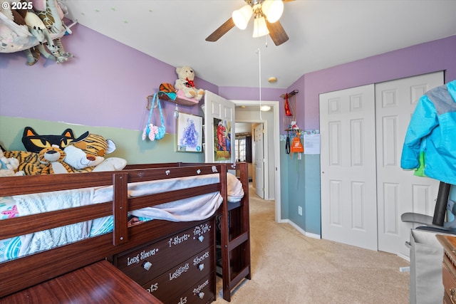 bedroom with light carpet, ceiling fan, and a closet