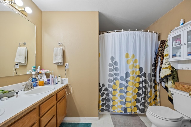 bathroom with vanity, toilet, and curtained shower