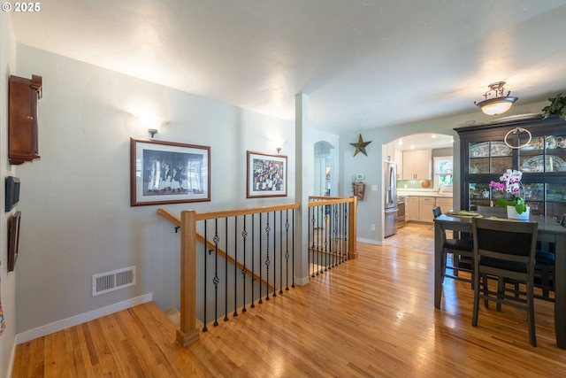 2507 NE 59th St, Vancouver, WA 98663 - corridor with an upstairs landing, light wood-type flooring, baseboards, and arched walkways