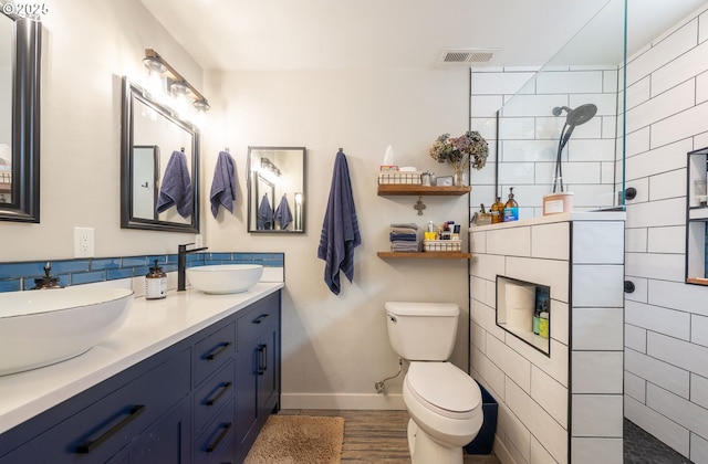2507 NE 59th St, Vancouver, WA 98663 - bathroom with a walk in shower, baseboards, toilet, double vanity, and wood finished floors