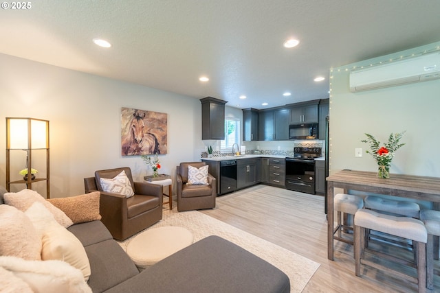 2507 NE 59th St, Vancouver, WA 98663 - living room featuring an AC wall unit, light wood-style flooring, and recessed lighting