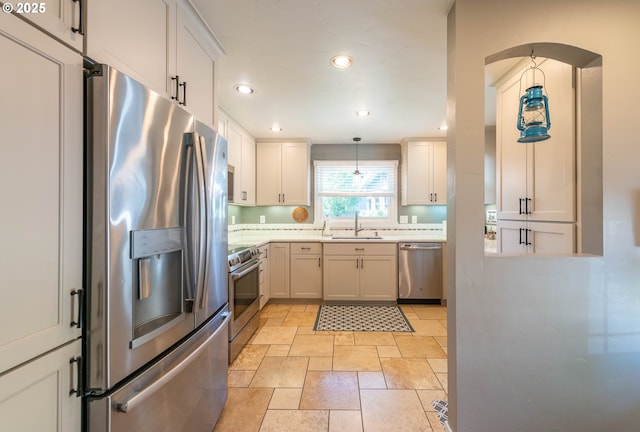 2507 NE 59th St, Vancouver, WA 98663 - kitchen featuring stainless steel appliances, a sink, stone tile floors, recessed lighting, and hanging light fixtures