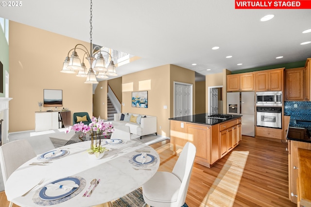 dining room featuring a notable chandelier and light hardwood / wood-style flooring