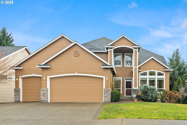 view of front of house with a garage and a front lawn