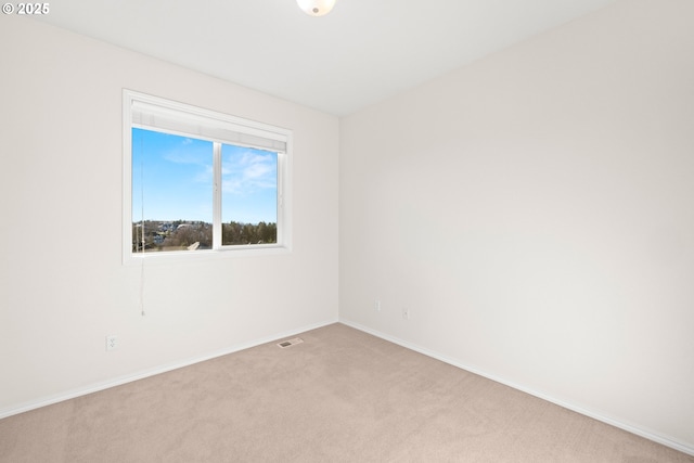 spare room with light colored carpet