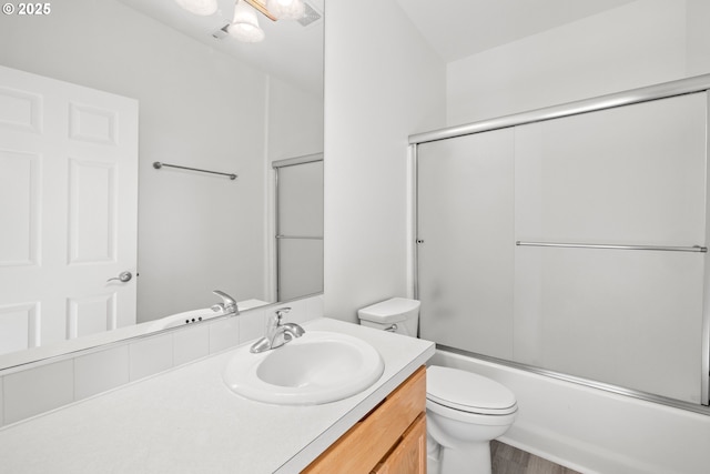 full bathroom with toilet, shower / bath combination with glass door, vanity, and hardwood / wood-style floors