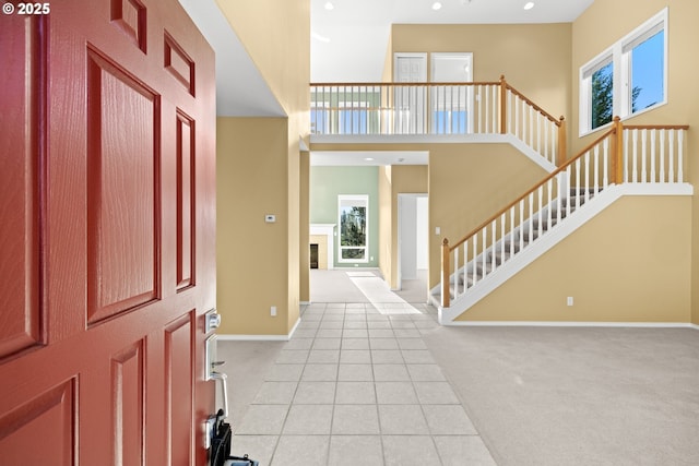 tiled foyer with a towering ceiling