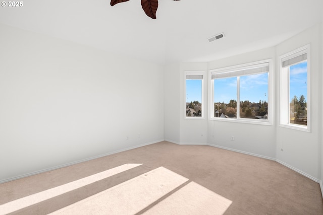 unfurnished room featuring light colored carpet and ceiling fan