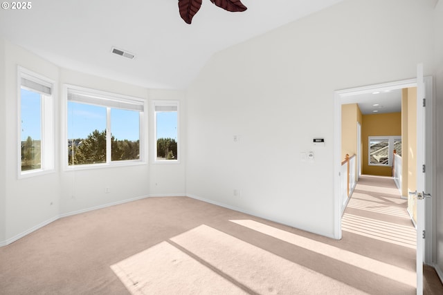 carpeted spare room with lofted ceiling and ceiling fan