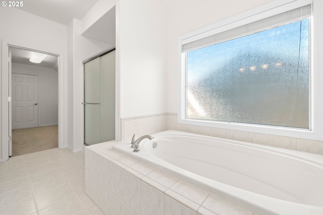 bathroom featuring tile patterned flooring and separate shower and tub