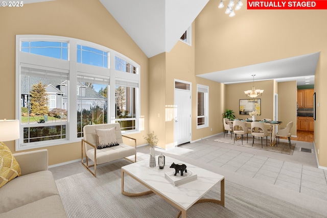 living room with a high ceiling and an inviting chandelier