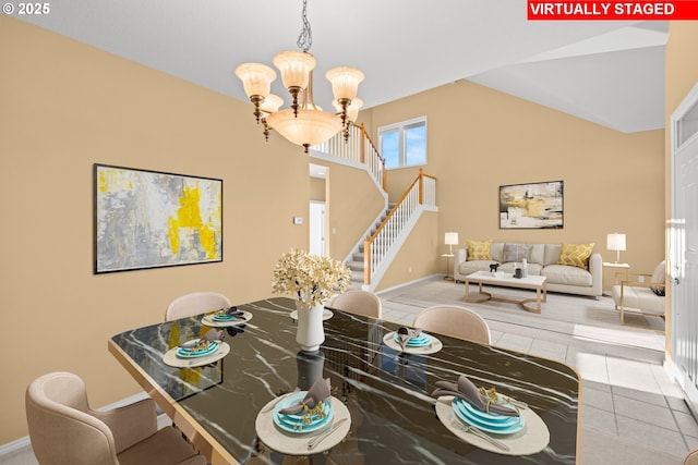 dining space with vaulted ceiling, a notable chandelier, and tile patterned floors