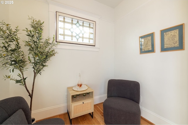 sitting room featuring baseboards and wood finished floors