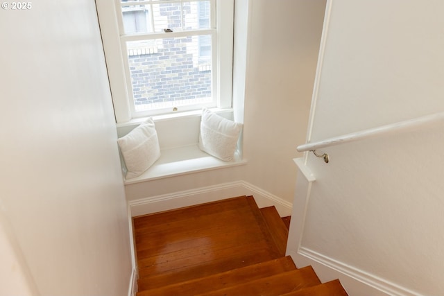 stairs featuring a wealth of natural light and baseboards