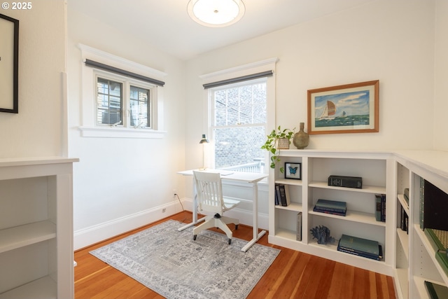 office area featuring baseboards and wood finished floors