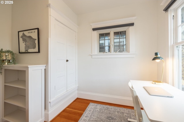 bathroom featuring wood finished floors and baseboards