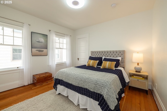 bedroom featuring baseboards and wood finished floors