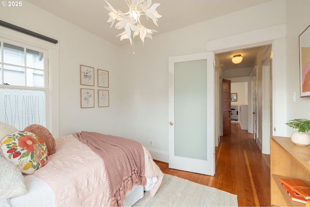 bedroom featuring baseboards and wood finished floors