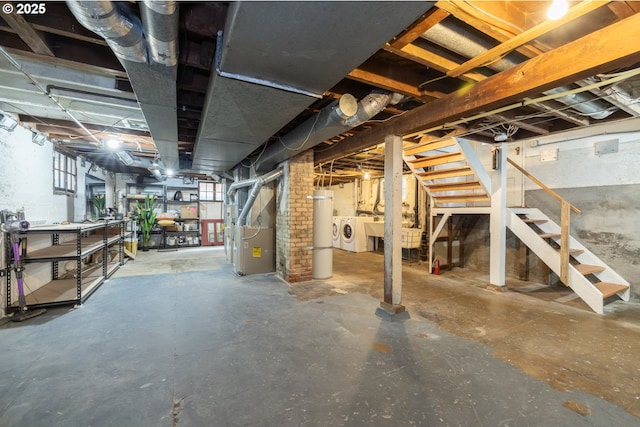 basement with independent washer and dryer, heating unit, and stairs