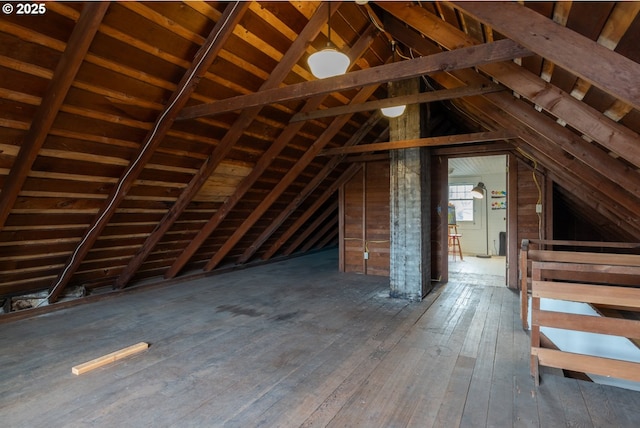 unfinished attic featuring an upstairs landing