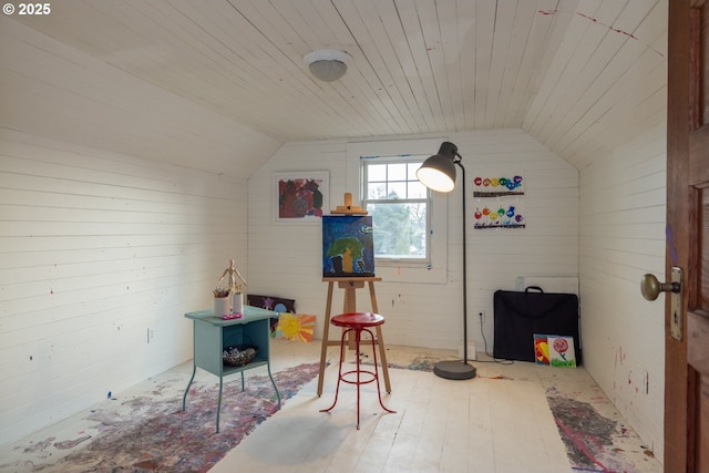 rec room with lofted ceiling, wood ceiling, wood walls, and wood finished floors