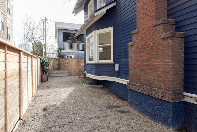 view of side of property featuring fence