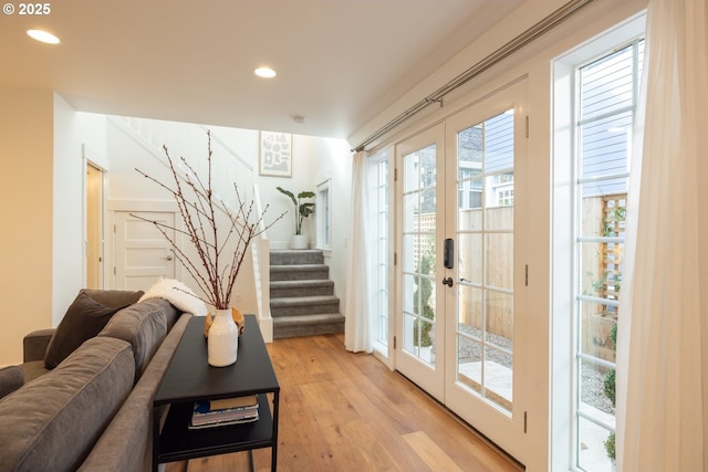 doorway to outside with light wood-style floors, recessed lighting, stairs, and french doors