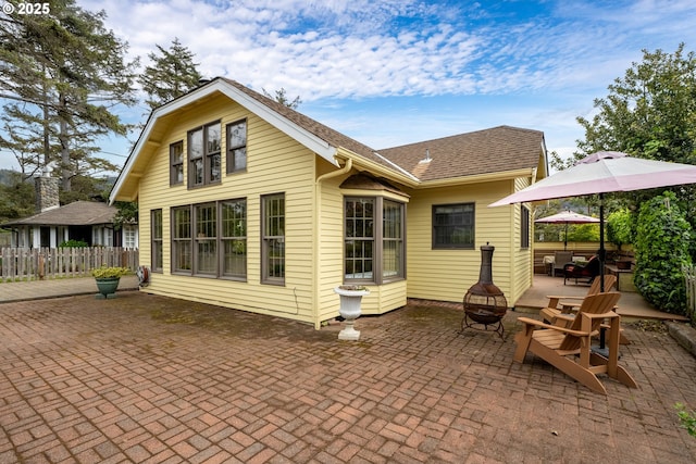 4445 Independence Ave, Neskowin, OR 97149 - rear view of house with a fire pit and a patio