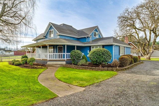 view of front of house with covered porch and a front yard