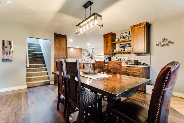 dining room featuring dark hardwood / wood-style floors and a textured ceiling