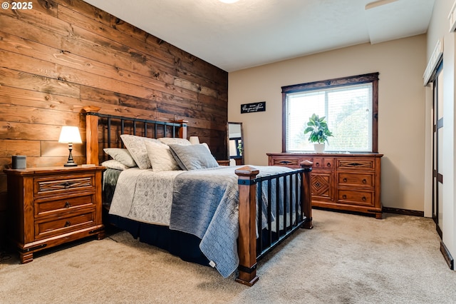 carpeted bedroom with wood walls