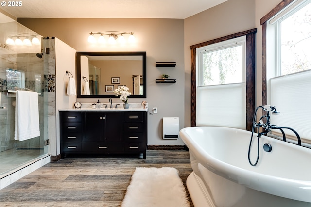 bathroom with vanity, wood-type flooring, and shower with separate bathtub