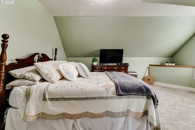 carpeted bedroom with vaulted ceiling and a textured ceiling