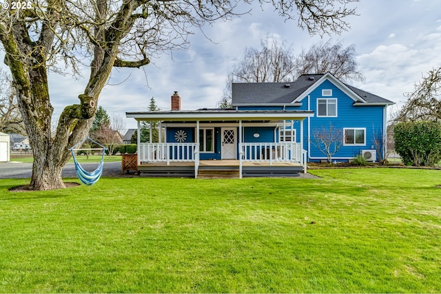 back of property featuring a wooden deck and a yard