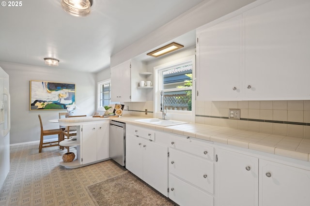 17787 Kelok Rd, Lake Oswego, OR 97034 - kitchen with stainless steel dishwasher, open shelves, backsplash, a sink, and white cabinetry