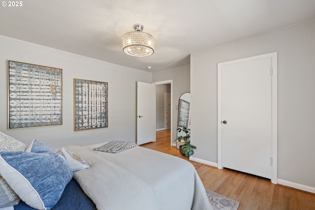 17787 Kelok Rd, Lake Oswego, OR 97034 - bedroom with light wood-type flooring, a chandelier, and baseboards