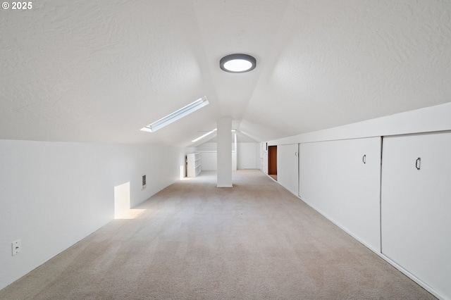17787 Kelok Rd, Lake Oswego, OR 97034 - additional living space featuring vaulted ceiling, light carpet, a skylight, and a textured ceiling
