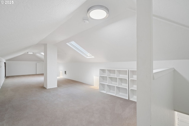 17787 Kelok Rd, Lake Oswego, OR 97034 - additional living space featuring a skylight, carpet floors, vaulted ceiling, and a textured ceiling