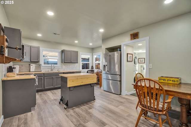 217 N Molalla Ave, Molalla, OR 97038 - kitchen featuring high quality fridge, gray cabinetry, a center island, decorative backsplash, and light wood-type flooring