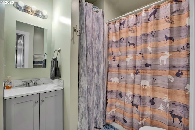 bathroom featuring vanity and a shower with shower curtain