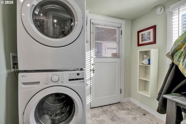 clothes washing area with stacked washer and dryer