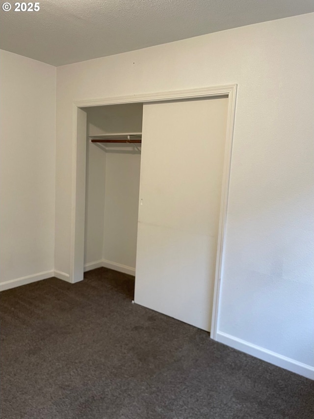217 N Molalla Ave, Molalla, OR 97038 - unfurnished bedroom featuring dark carpet and a closet