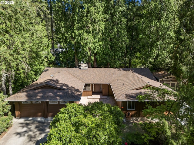 drone / aerial view featuring a forest view