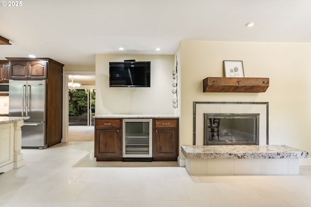 interior space featuring beverage cooler, recessed lighting, and an inviting chandelier