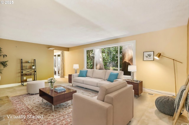 living room with baseboards and visible vents