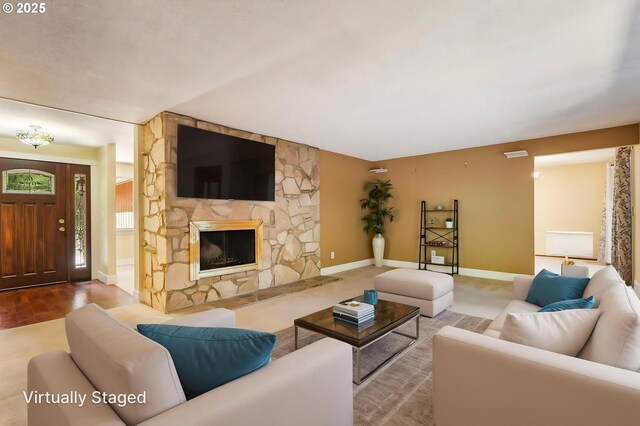 living room with baseboards, wood finished floors, and a fireplace