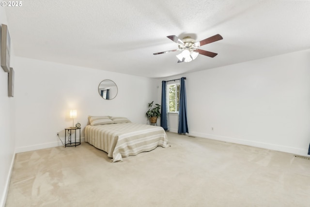 bedroom featuring baseboards, a ceiling fan, and light carpet