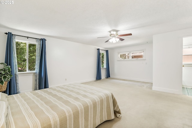 bedroom with carpet floors, a ceiling fan, and baseboards