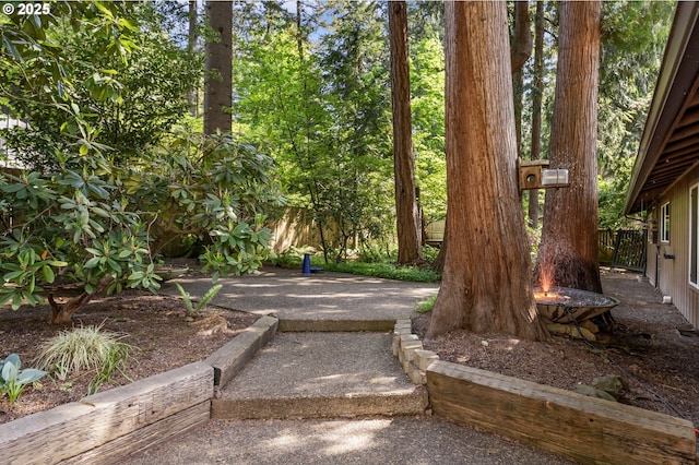 view of yard with fence and a fire pit