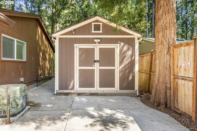 view of shed with fence